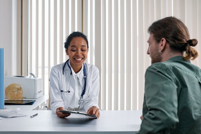 a doctor talking with a patient in their office